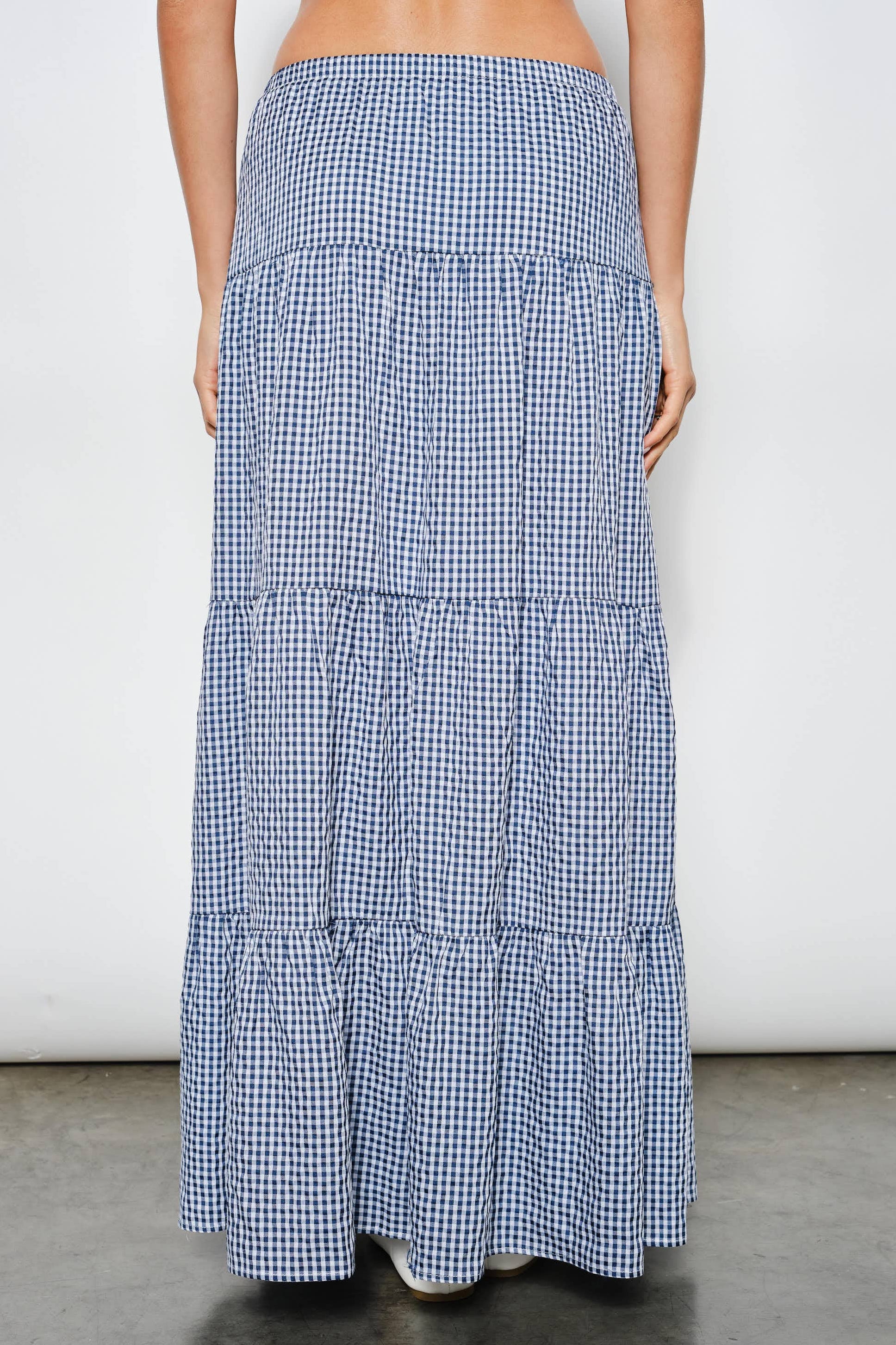 Long blue and white checkered skirt on a plain background