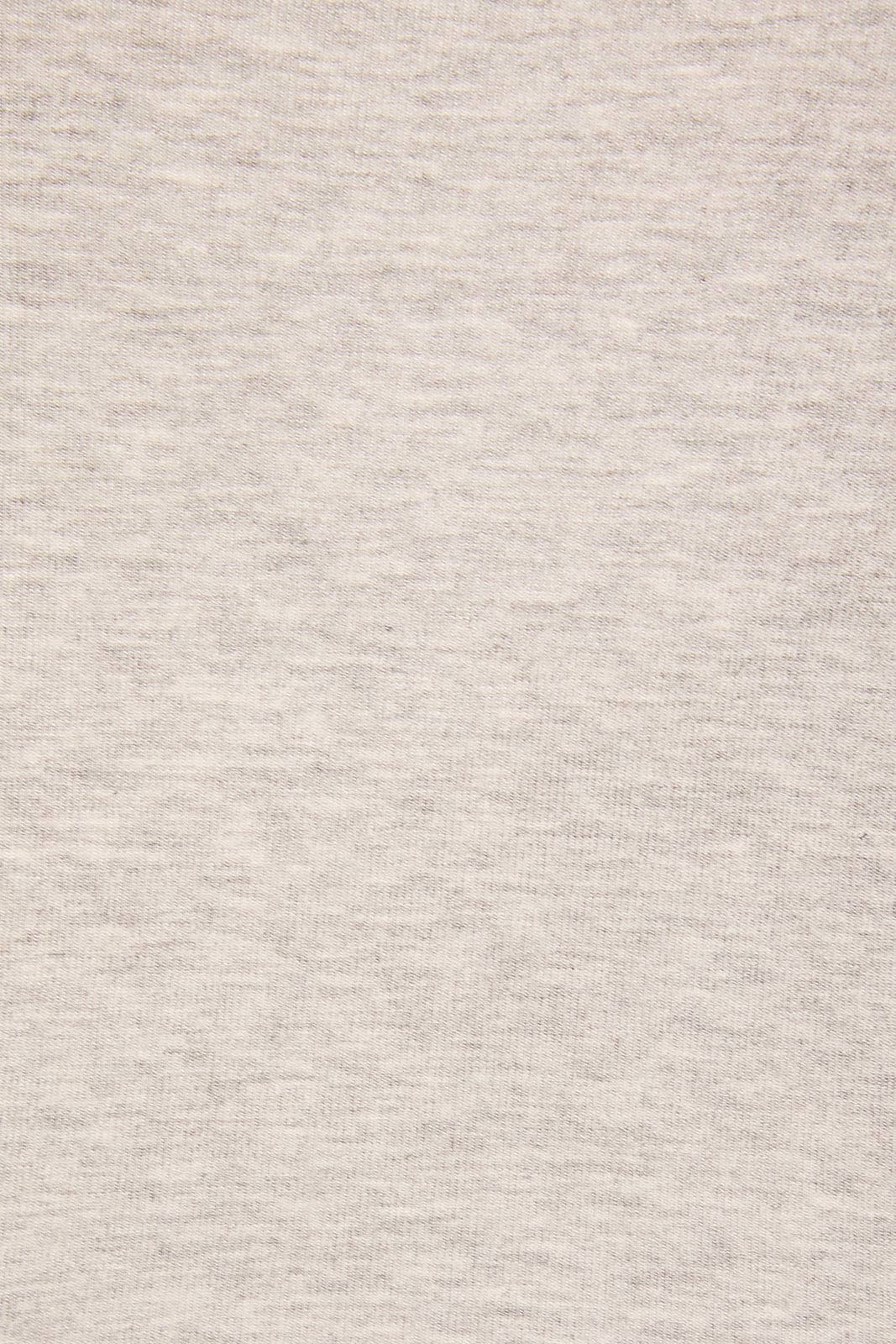 A close-up of a light heather gray fabric texture, showing the fine knit pattern and subtle gray and off-white flecks.