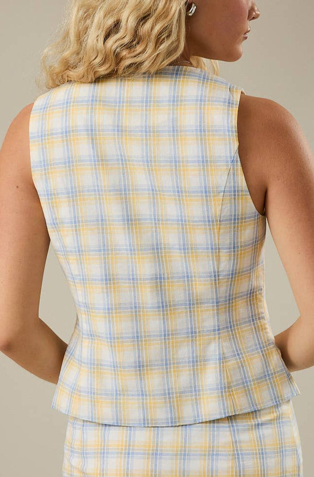 Plaid top with a matching skirt on a neutral background