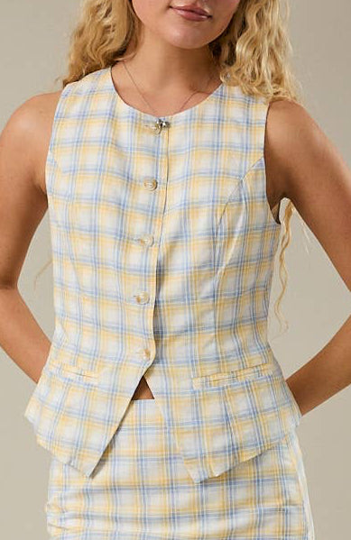 Yellow and blue plaid top on a neutral background