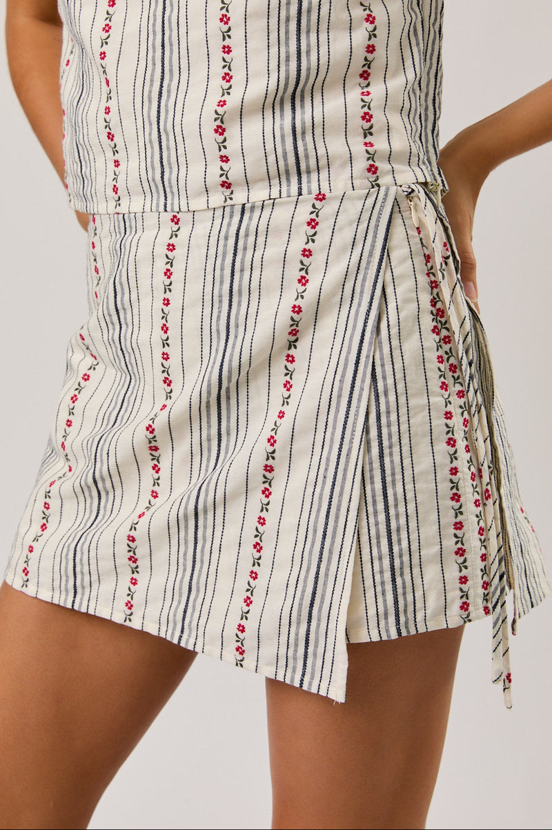 Striped skort with floral details on a plain background