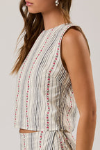 Woman wearing a sleeveless top and shorts set with a white background