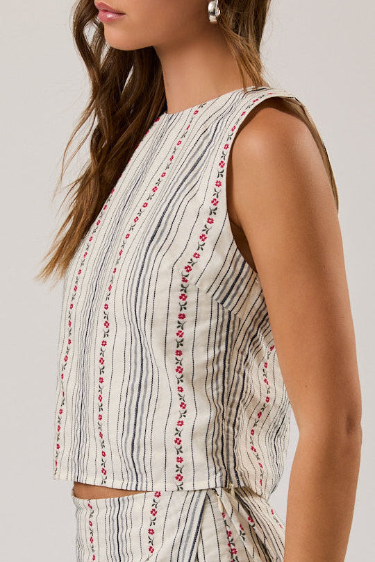 Woman wearing a sleeveless top and shorts set with a white background