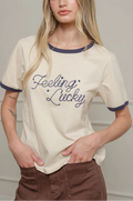 Woman wearing a white t-shirt with 'Feeling Lucky' text against a plain background