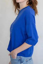 Woman wearing a blue shirt against a plain background