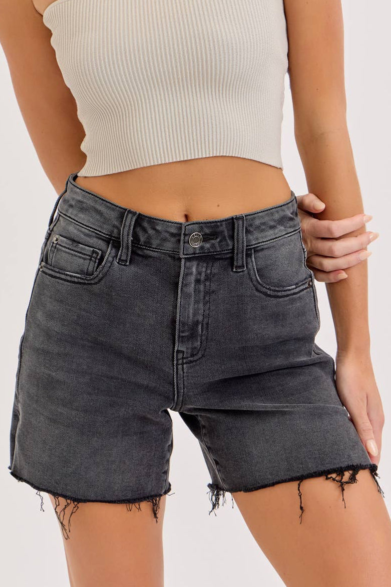 Woman wearing a strapless top and denim shorts on a white background