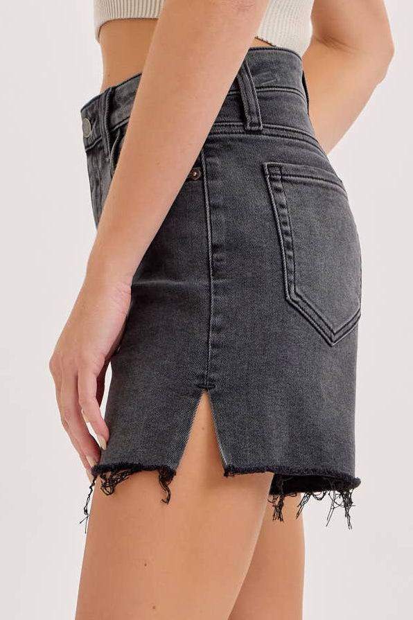 Person wearing a gray denim skirt on a white background