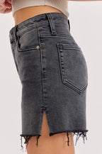 Black denim skirt worn by a person on a light gray background