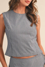 Woman wearing a sleeveless striped top on a beige background