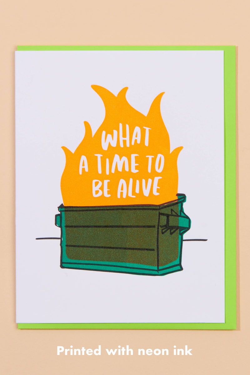 Card with flames and text 'What a time to be alive' on a beige background