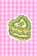 Green layered cake illustration on a pink checkered background