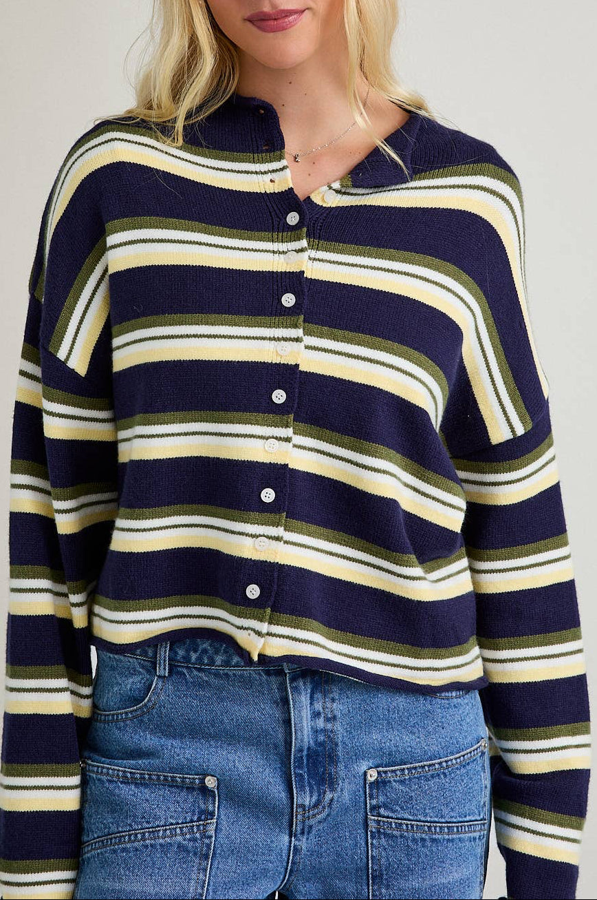 Woman wearing a striped sweater with a plain background