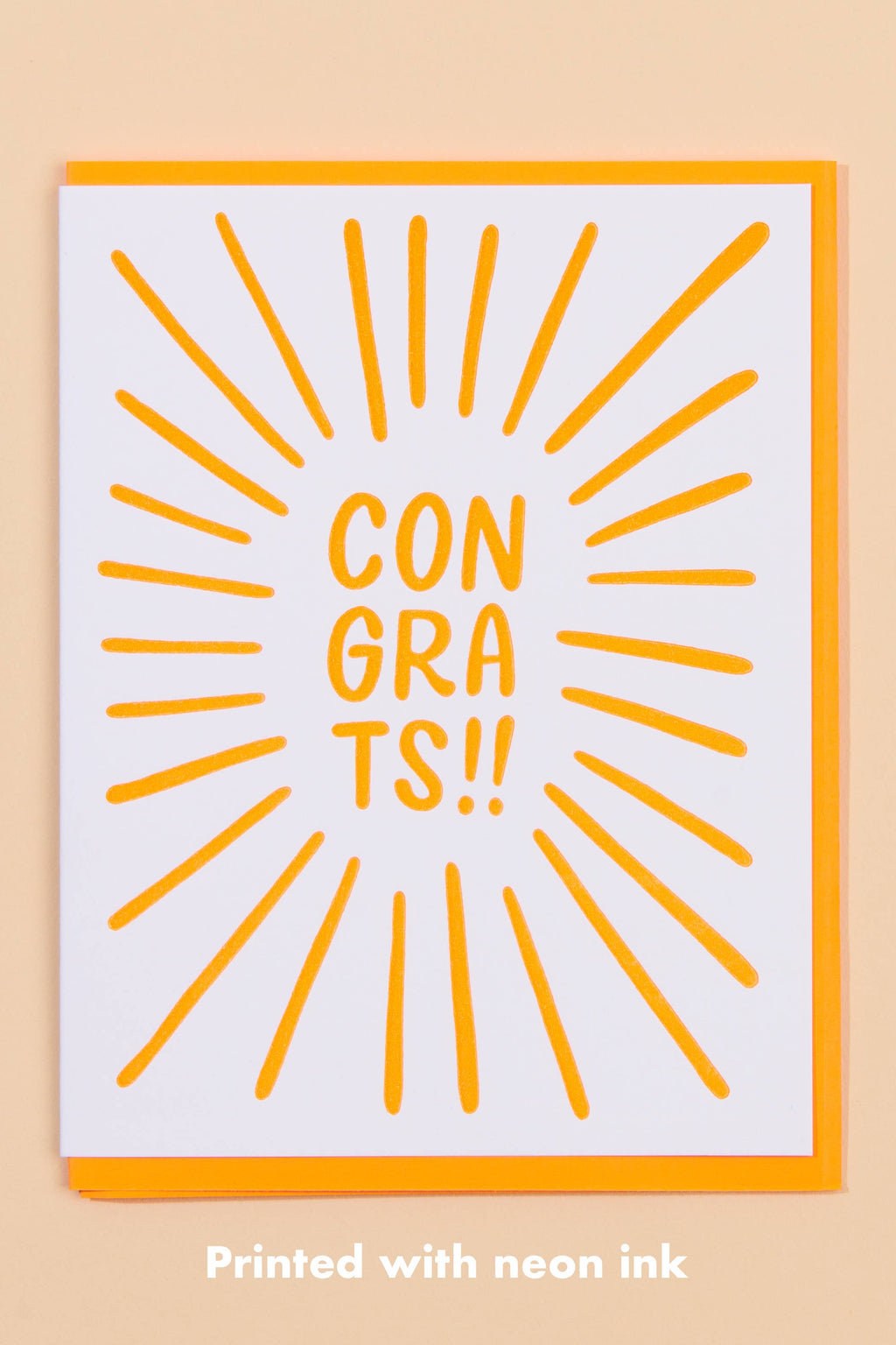 Greeting card with 'CON GRA TS!!' text and sunburst design on a beige background