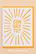 Greeting card with 'CON GRA TS!!' text and sunburst design on a beige background