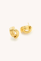 Pair of gold hoop earrings on a white background