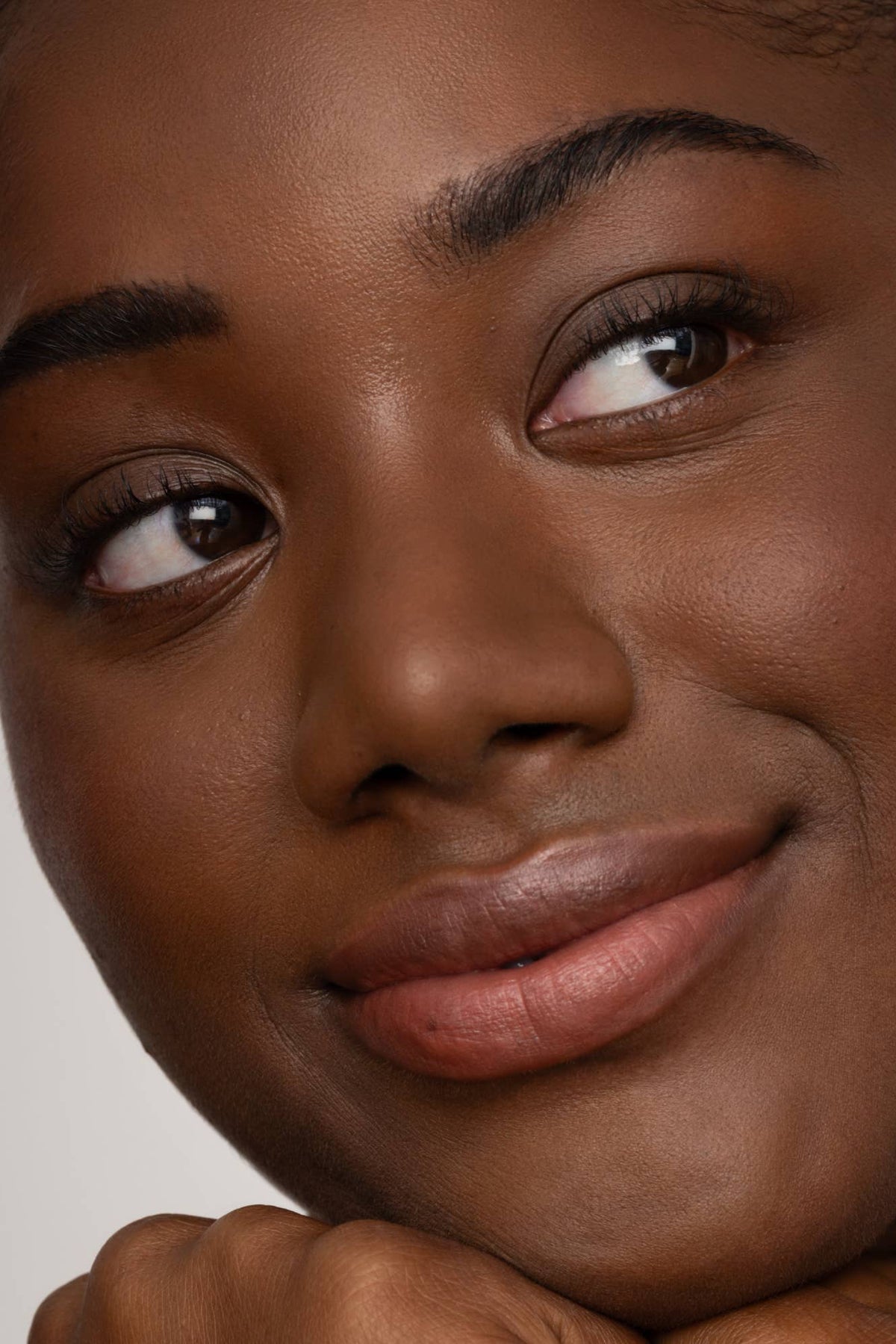 Close-up of a woman's face with a neutral background