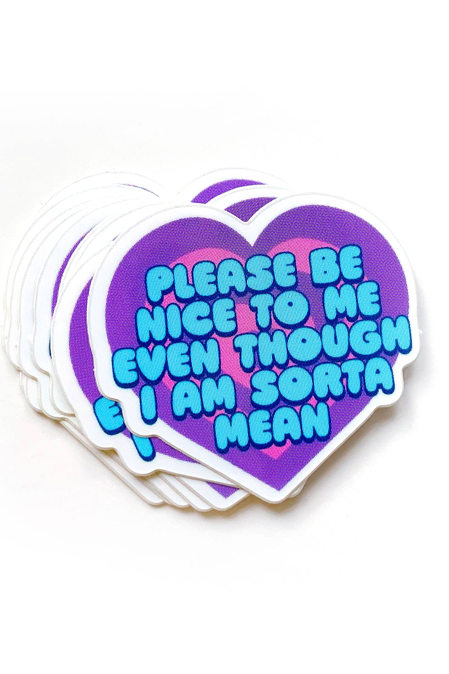 Stack of heart-shaped stickers with text on a white background