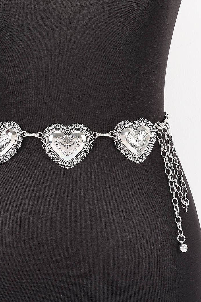 Silver heart-shaped belt on a black mannequin