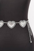 Silver heart-shaped belt on a black mannequin
