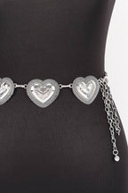 Silver heart-shaped belt on a black mannequin