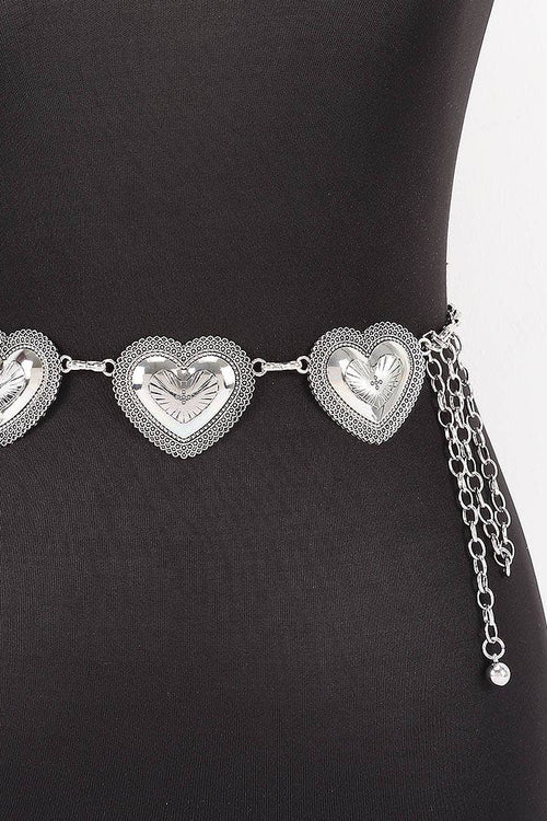 Silver heart-shaped belt on a black mannequin