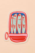 Die-cut vinyl sticker depicting a colorful illustration of sardines in a tin can, featuring artwork by Meghan Hopkins Sokor. The sticker measures approximately 3 inches, is waterproof, durable, and suitable for outdoor use.