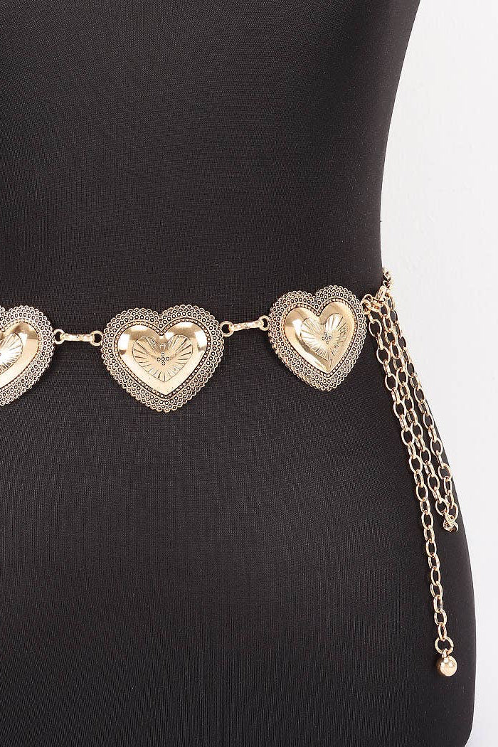 Gold heart-shaped belt on a black mannequin