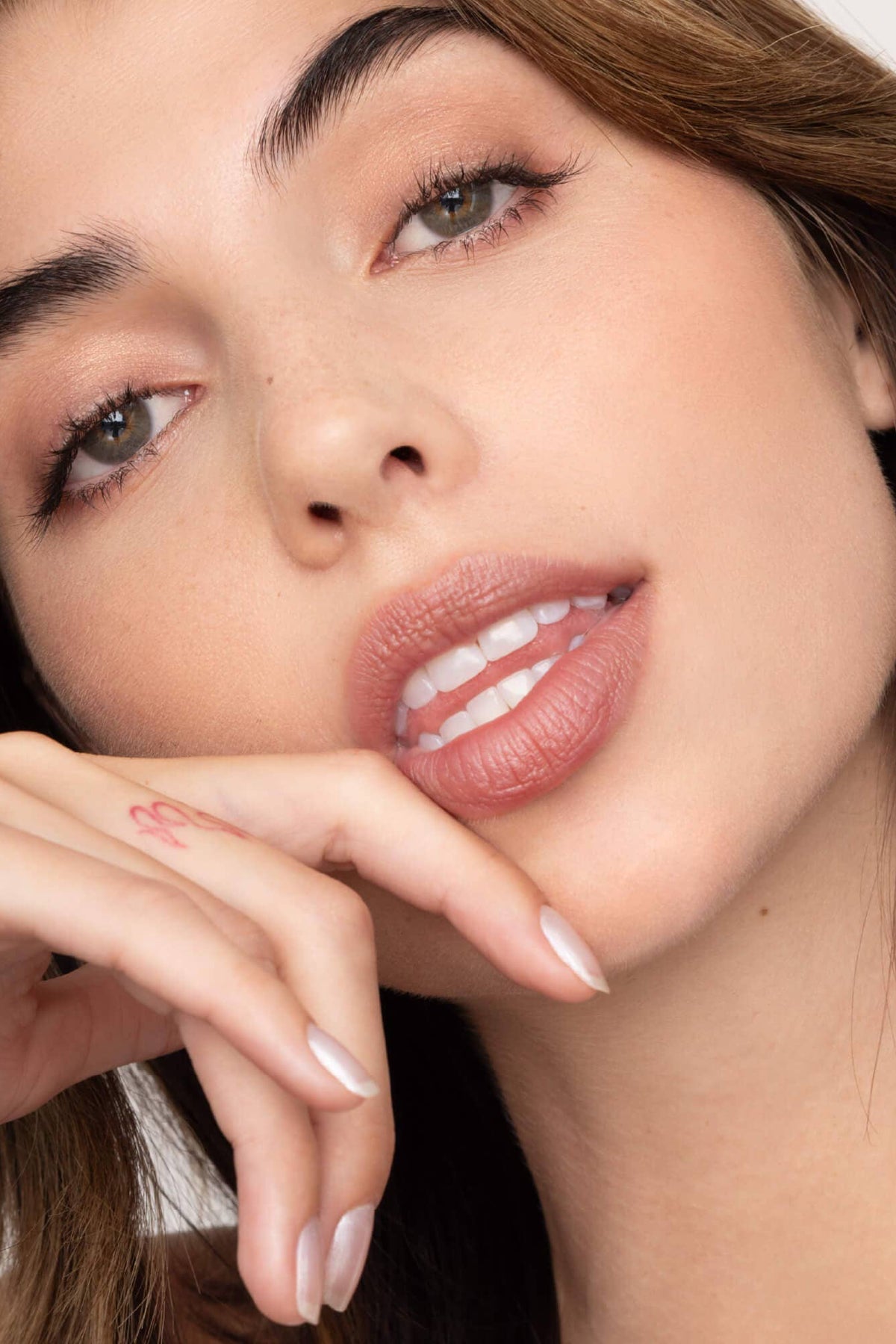 Close-up of a woman with a neutral background