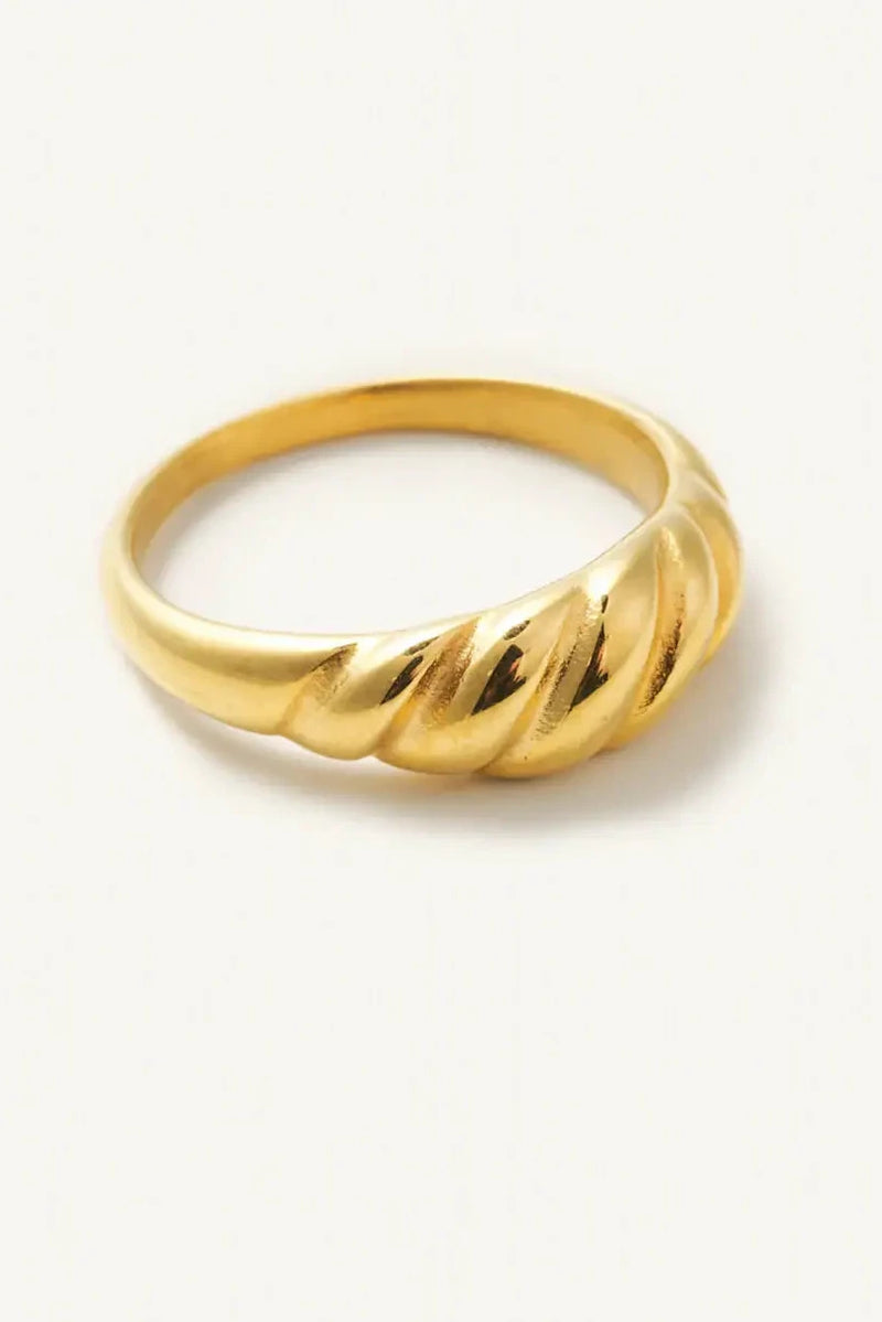 Gold ring with a twisted design on a white background