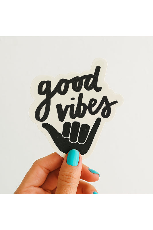 Hand holding a 'good vibes' sticker with a black hand symbol on a white background