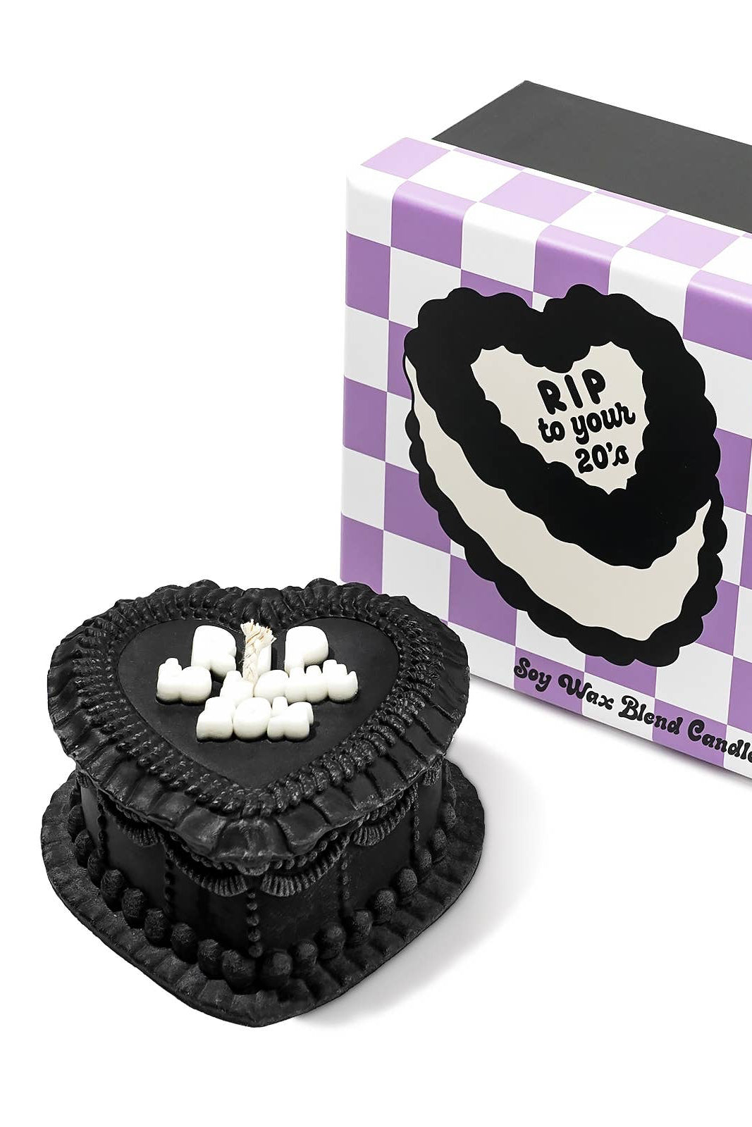Black heart cake-shaped candle with white text next to a purple and white checkered box. rip to your 20's