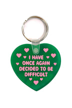 Green heart-shaped keychain with pink text and hearts on a white background