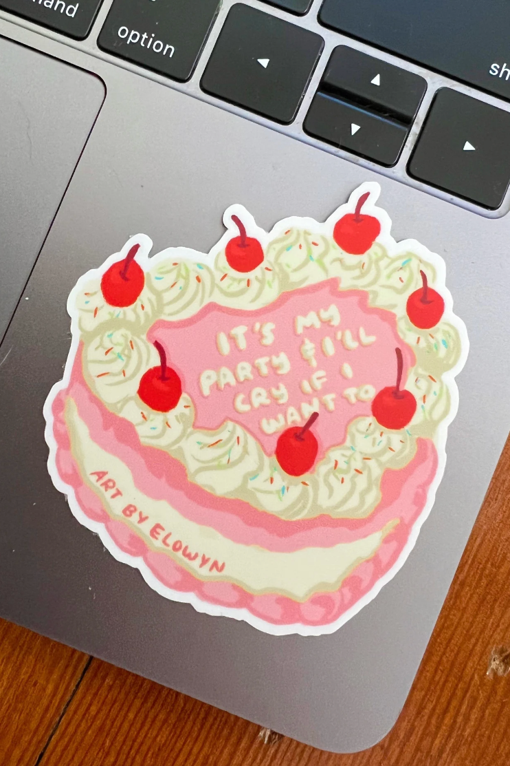 Sticker of a cake with red cherries on a laptop keyboard