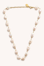 Pearl necklace with gold chain on a white background