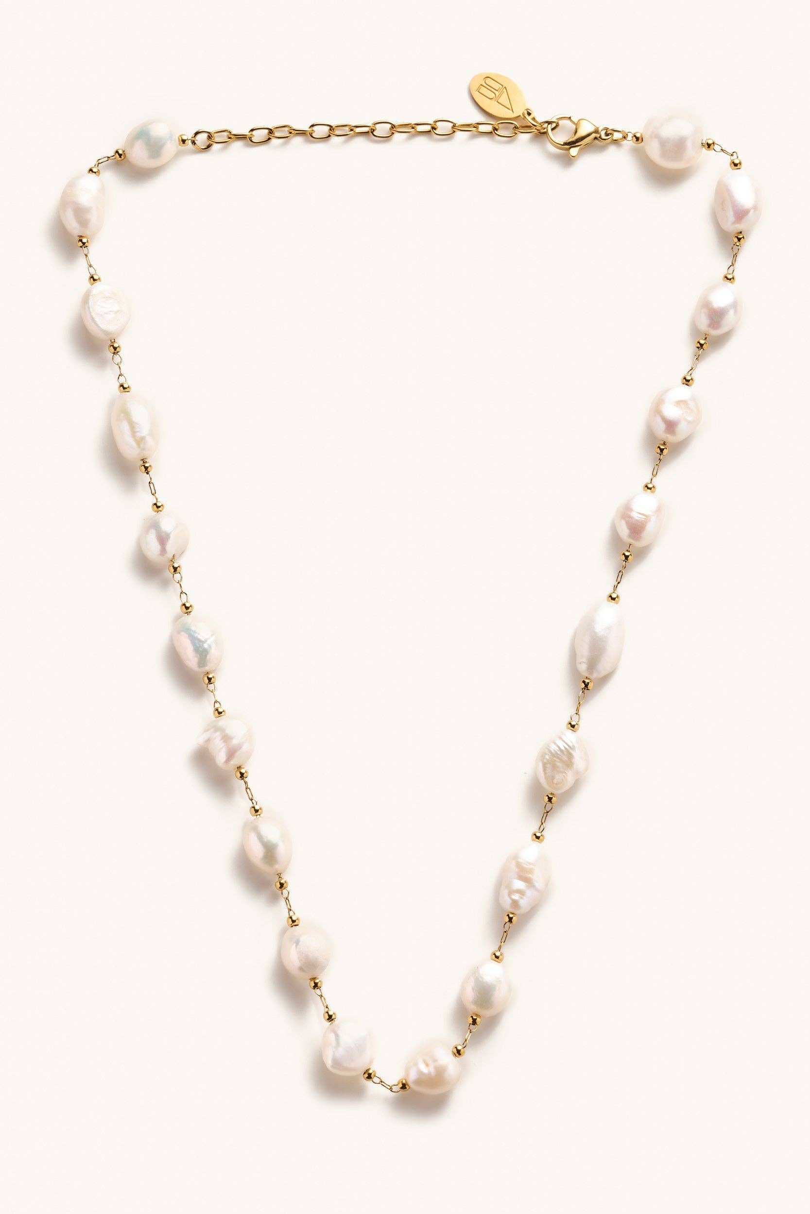 Pearl necklace with gold chain on a white background