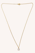 Gold necklace with a small pendant on a white background