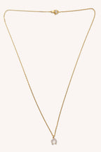 Gold necklace with a small pendant on a white background