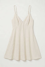 Beige slip dress on a white background
