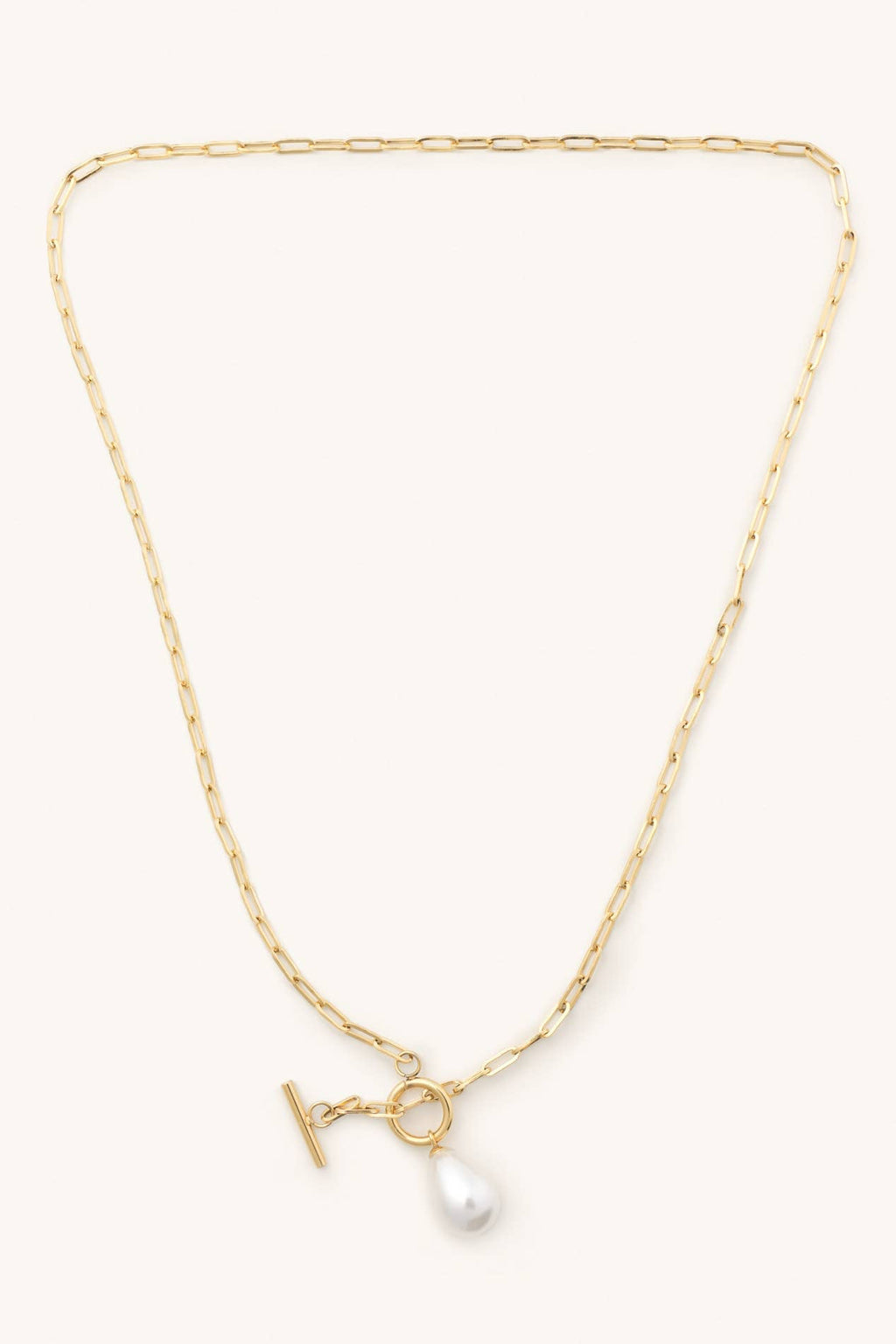 Gold necklace with a pearl pendant on a white background