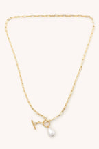 Gold necklace with a pearl pendant on a white background