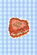 Sticker with 'Leo Baby' design on a blue checkered background zodiac_cake_sticker_Leo_baby
