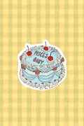 Sticker with cake design and 'Pisces Baby' text on a yellow and green striped background